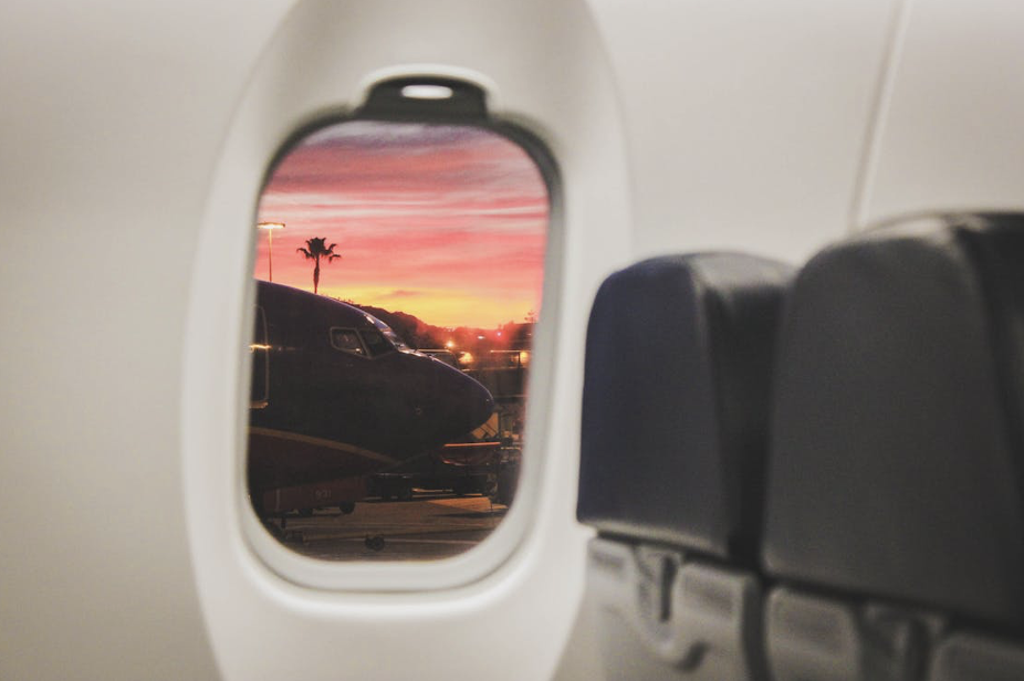 A view through the window of a commercial airplane, symbolizing the adventures awaiting families who travel